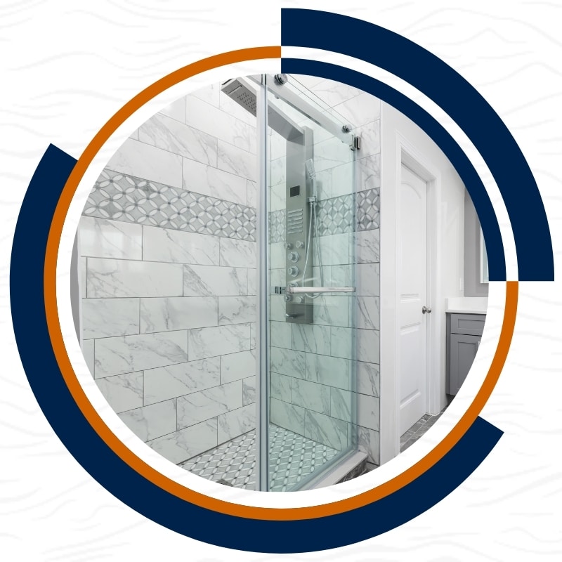 A sleek shower with a glass door and white tile flooring, showcasing improvements made to address leaking shower repairs in Castlecrag