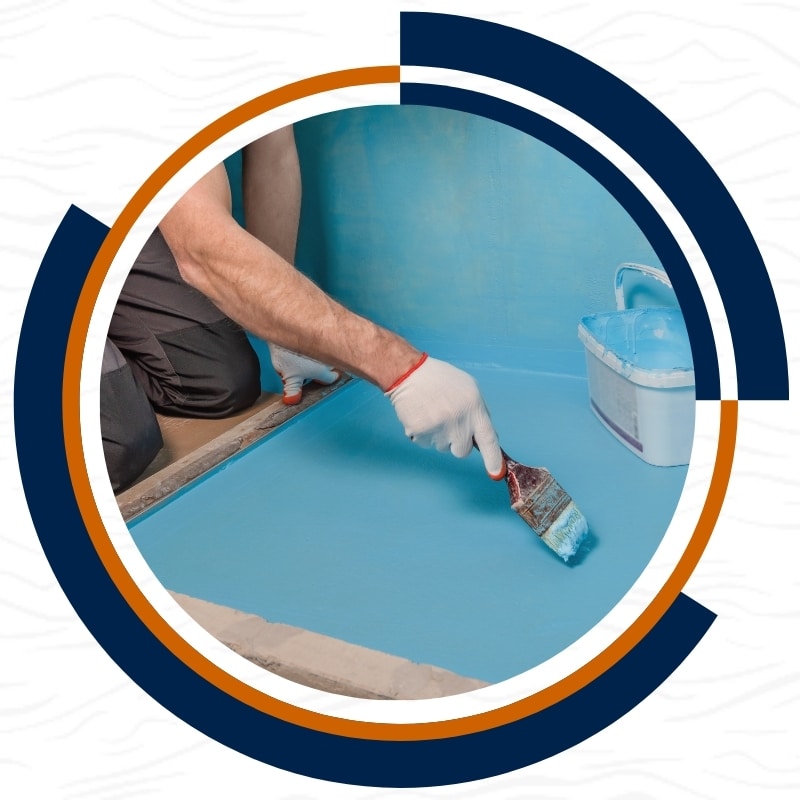 A worker doing a waterproofing service to a concrete surface using a brush, ensuring a long-lasting seal for Waterproofing in Nelson
